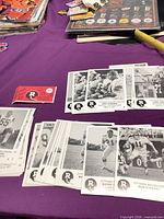 Spread of multiple Ottawa Rough Riders black-and-white player photocards on table