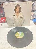 Front sleeve featuring Shaun Cassidy with vinyl record displayed