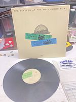 Front cover showing title and ticket graphics alongside vinyl record