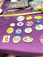 Group view of assorted buttons beside tape measure showing size range