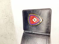 Wallet opened showing affixed badge