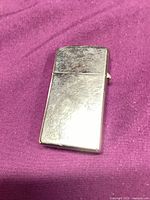 Front view of polished chrome Zippo lighter showing overall wear
