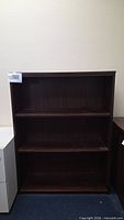 Front view showing full bookcase with three shelves
