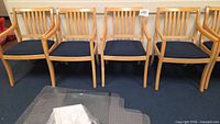 Five matching wood armchairs front view