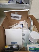 Overview of box contents: film pack, wipes canister, Telfa box, sterile packets