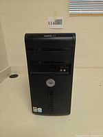 Front view of Dell Vostro 200 tower showing ports, stickers, cosmetic wear