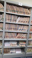 Front view of lateral file cabinet filled with files