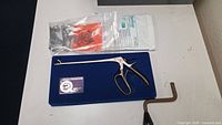 All items on tabletop including biopsy punch, SteriGage pack, Allen wrench, bag of hardware