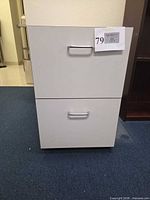Front view of white two-drawer file cabinet with chrome handles