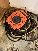 Reel and cords coiled on floor showing overall contents
