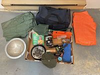 Overall lot with tarps, duffel, shovel, cookware, stove, towel, pad, headlamp