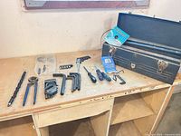 Overall view of toolbox and tools laid out on bench