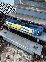 Broadstone camping cot inside blue carry bag on steps