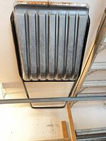 Full view of metal tub and frame mounted to ceiling