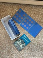 Overview of book, blue folders inside and beside white box