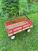 Full view of wooden wagon showing overall design, rails, wheels and Home Delivery logo