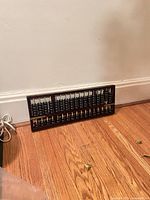 Front view of entire wooden abacus leaning against wall