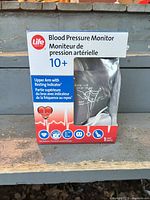Retail box showing LifeBrand blood pressure monitor, model 10+, cuff image and specifications