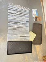 Entire lot laid out: runner, two boot trays, insulation kit box, yellow cloth