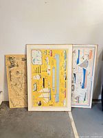 Front view of the three laminated posters standing together