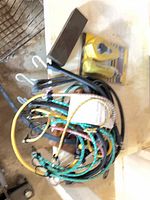 Coiled bungee cords, sharpening stone block, packaged chalk line kit