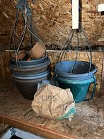 Stack of plastic hanging planters with terracotta pots nested, paper bag labeled Lime