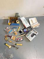 Overview of all painting tools, heat gun box, paint tray, scrapers, brushes, consumables