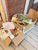 Two boxes with towels, toiletries and accessories
