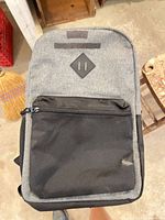 Front view of grey and black Outbound backpack