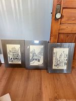 All three framed prints standing side by side