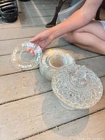 Stack of dessert plates beside covered candy dish showing overall lot
