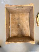 Top view inside showing wood slats, hole and wear