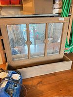 Front view showing glass panes, decorative muntins and attached planter box