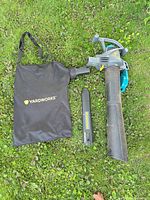 leaf blower with collection bag, round tube and flat nozzle on grass