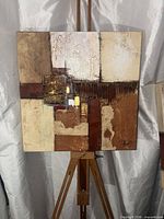 Front view of abstract painting on easel showing overall composition and signature