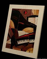 Full view of framed abstract artwork with piano keys motif