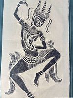 Close-up of the deity figure on handmade paper showing ink detail and paper texture