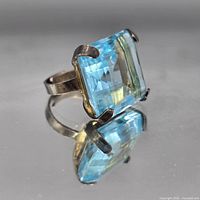 Top view showing square blue glass stone and prongs