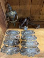 Group view: door knocker, four casters, eight drawer pulls