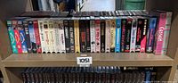 Full shelf view of approx. 40 VHS tapes in cases