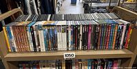 Full front view of approximately 50 DVDs on shelf