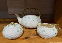 Group shot of teapot, sugar bowl and creamer showing overall design and condition