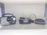 Full view of three radios on shelf