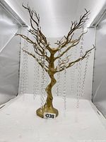 Full view of gold resin tree centerpiece with hanging clear bead strands