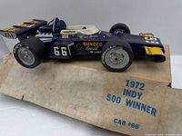 Top view of ceramic Indy 500 #66 decanter on box lid