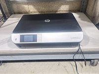 Top view of HP Envy 5530 printer showing overall condition and included power cable