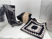 Full view of boots standing and tote bag laid flat