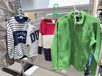 All four garments hanging on rack