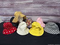Group shot of the eight hats