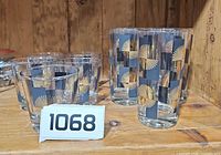 Group view of 5 small and 5 large glasses on shelf showing pattern